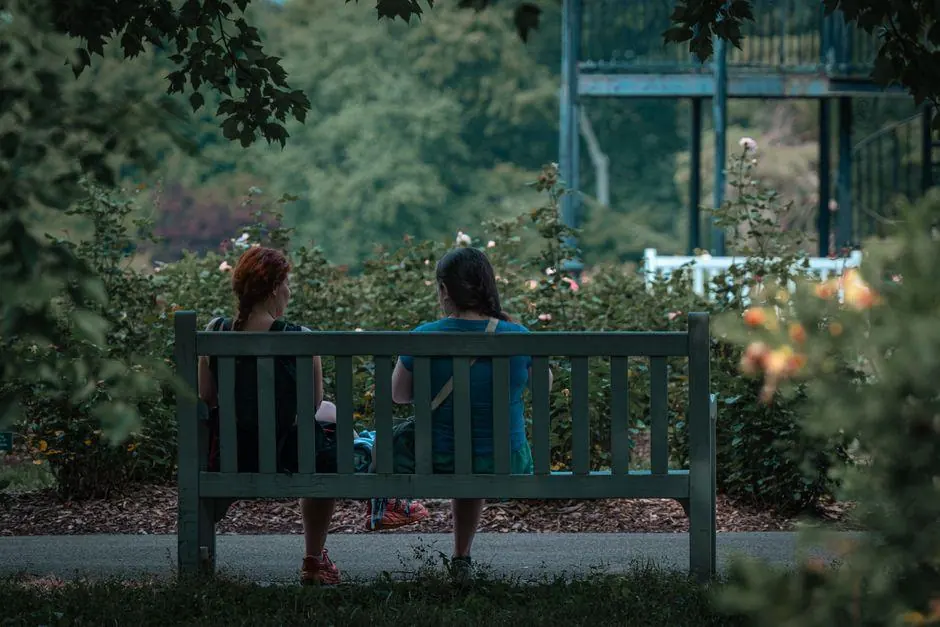Two people sitting together on a garden bench