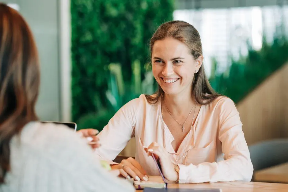 Woman smiling during a conversation across a cafe table