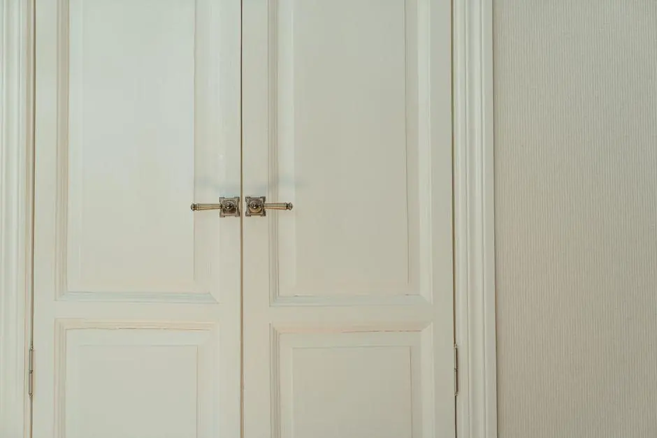 Closed white double doors with a metal latch