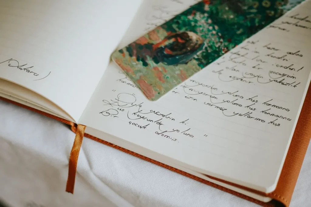 Handwritten journal pages with a colourful bookmark across the top