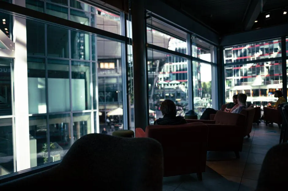 Armchairs beside large windows in a city cafe